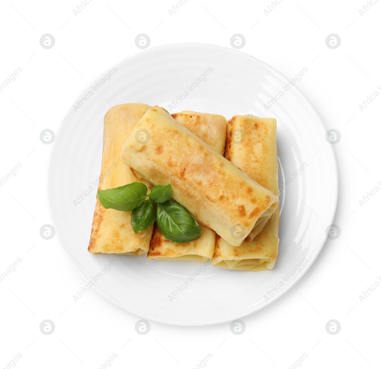 Photo of Delicious rolled crepes with basil isolated on white, top view