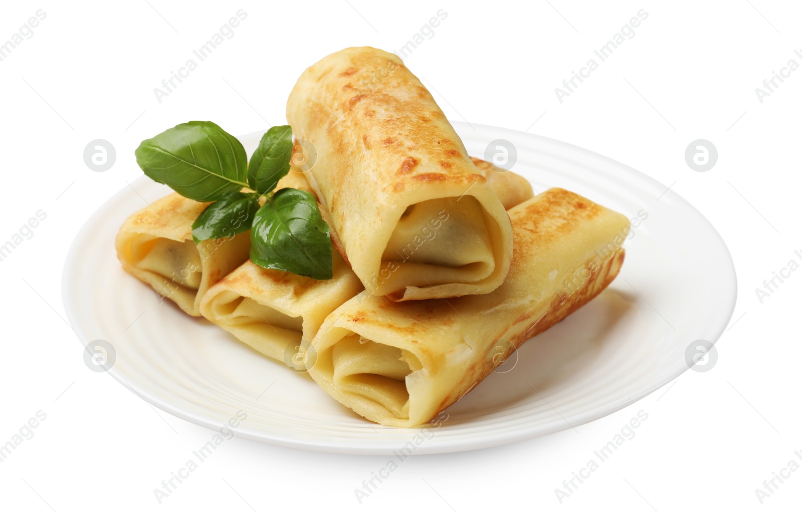 Photo of Delicious rolled crepes with basil isolated on white