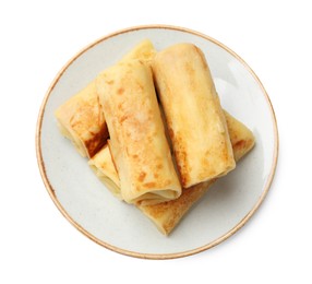 Photo of Delicious rolled crepes isolated on white, top view