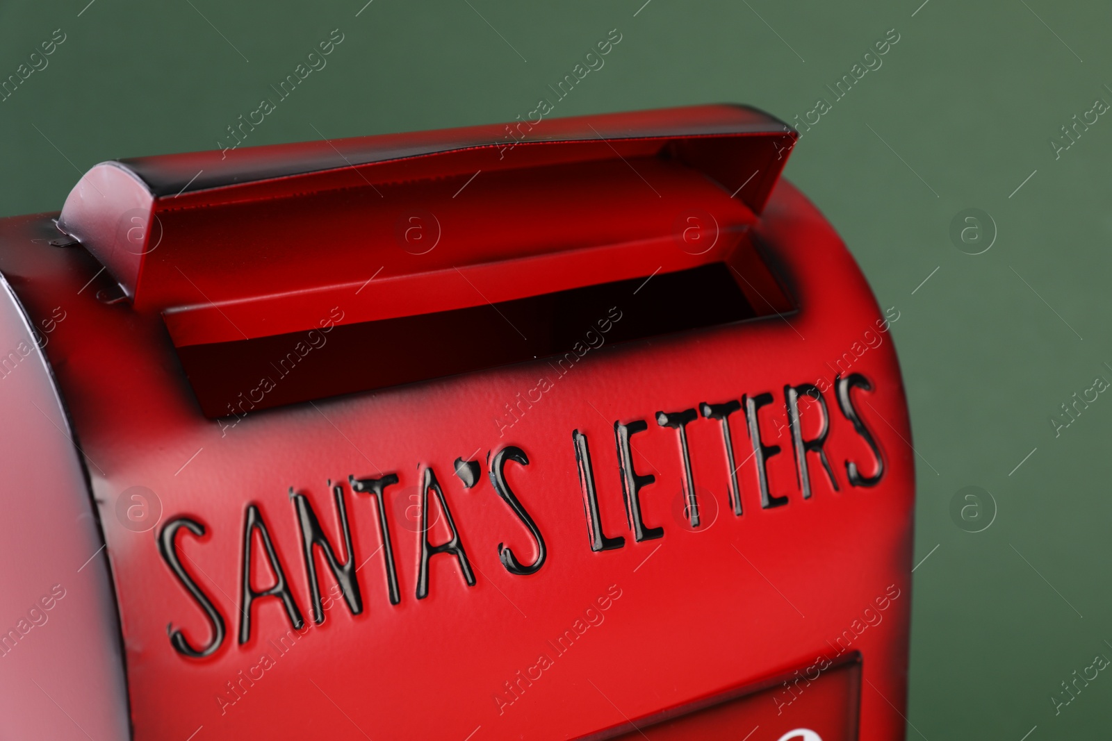 Photo of Santa Claus mail box on dark green background, closeup. Christmas tradition