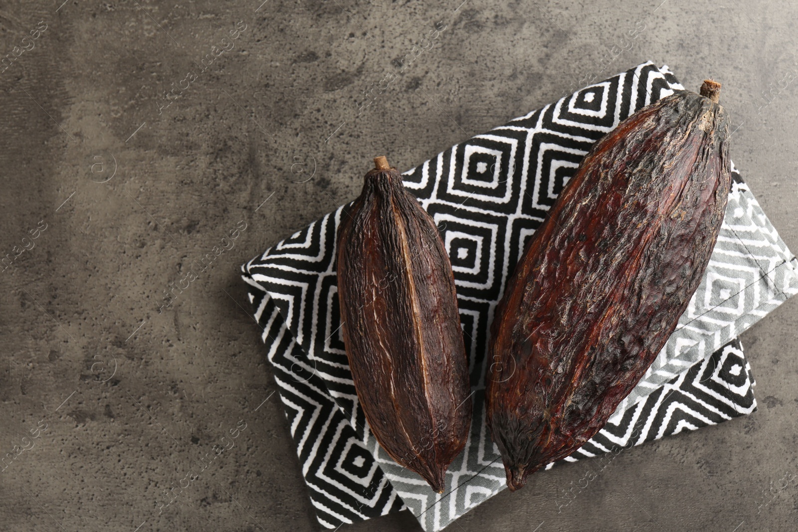 Photo of Cocoa pods on grey table, top view