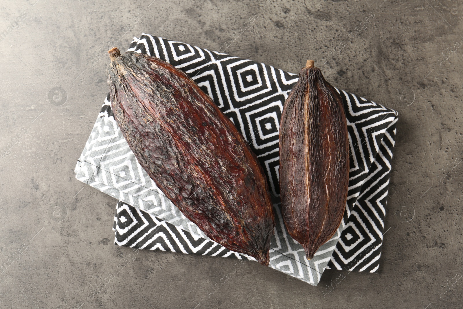 Photo of Cocoa pods on grey table, top view