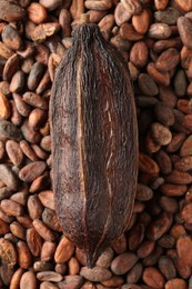 Photo of Natural cocoa pod on beans, top view