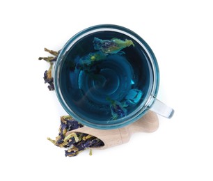 Photo of Butterfly pea flower tea in cup and scoop with buds isolated on white, top view