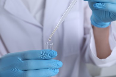 Photo of Laboratory testing. Scientist working with test tube, closeup