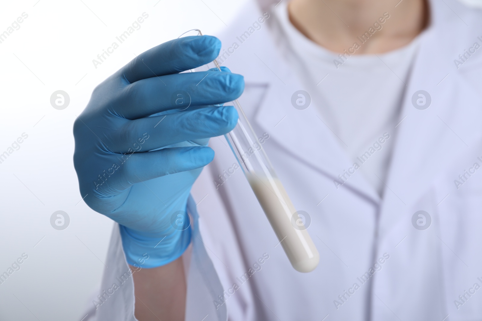 Photo of Laboratory testing. Scientist holding test tube with liquid, closeup