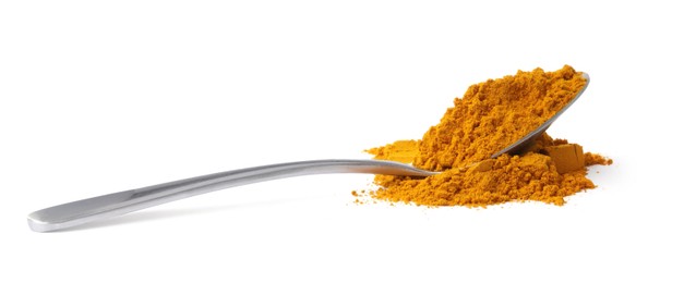 Photo of Turmeric powder and spoon isolated on white