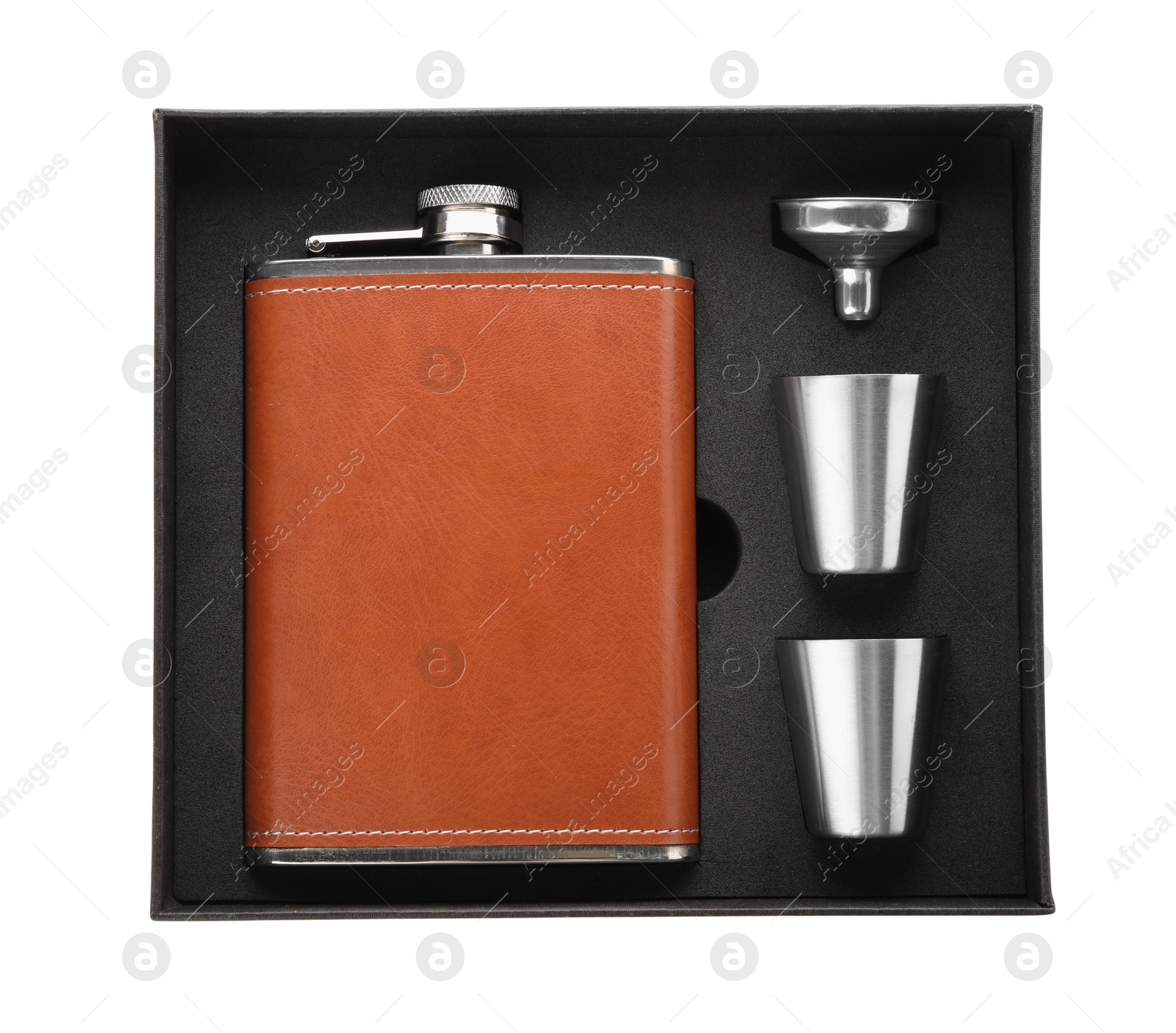 Photo of Hip flask, cups and funnel in package isolated on white, top view