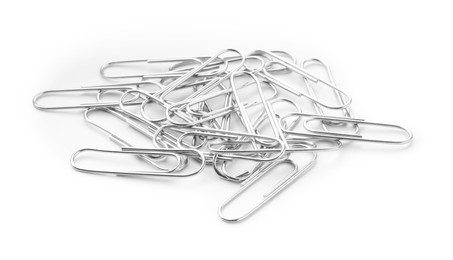 Photo of Pile of metal paper clips isolated on white, above view