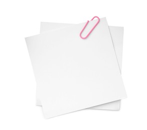 Photo of Blank paper notes attached with clip isolated on white, top view