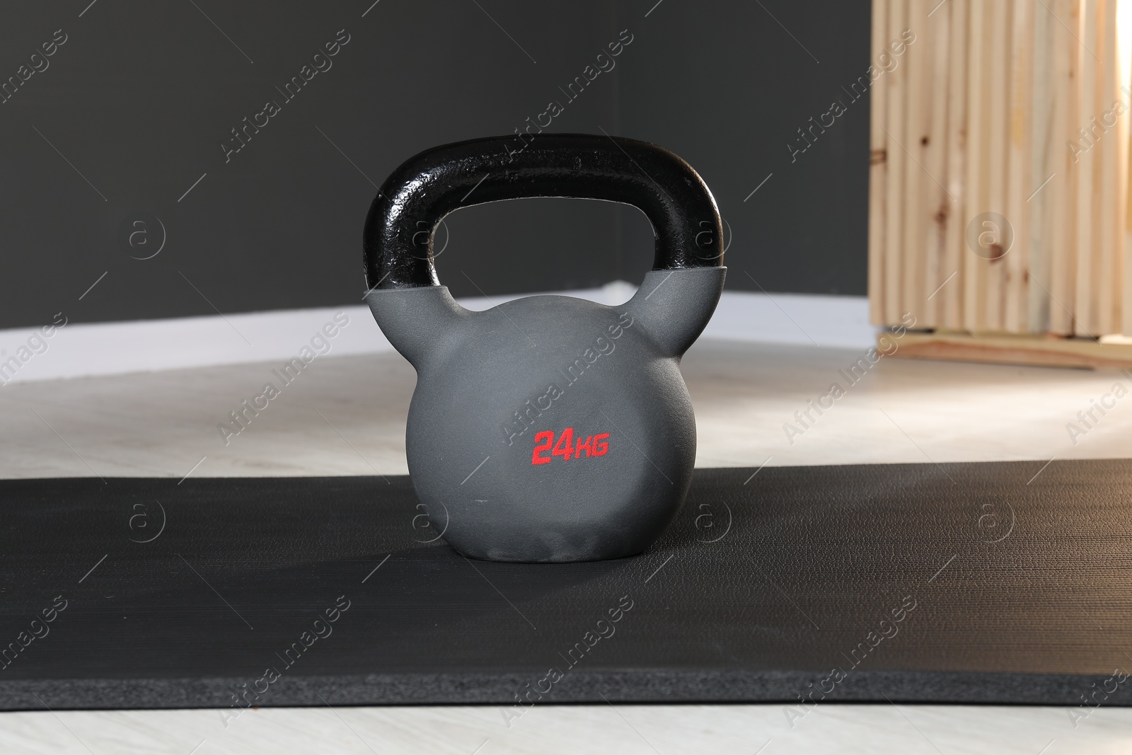 Photo of One kettlebell and mat on floor in gym