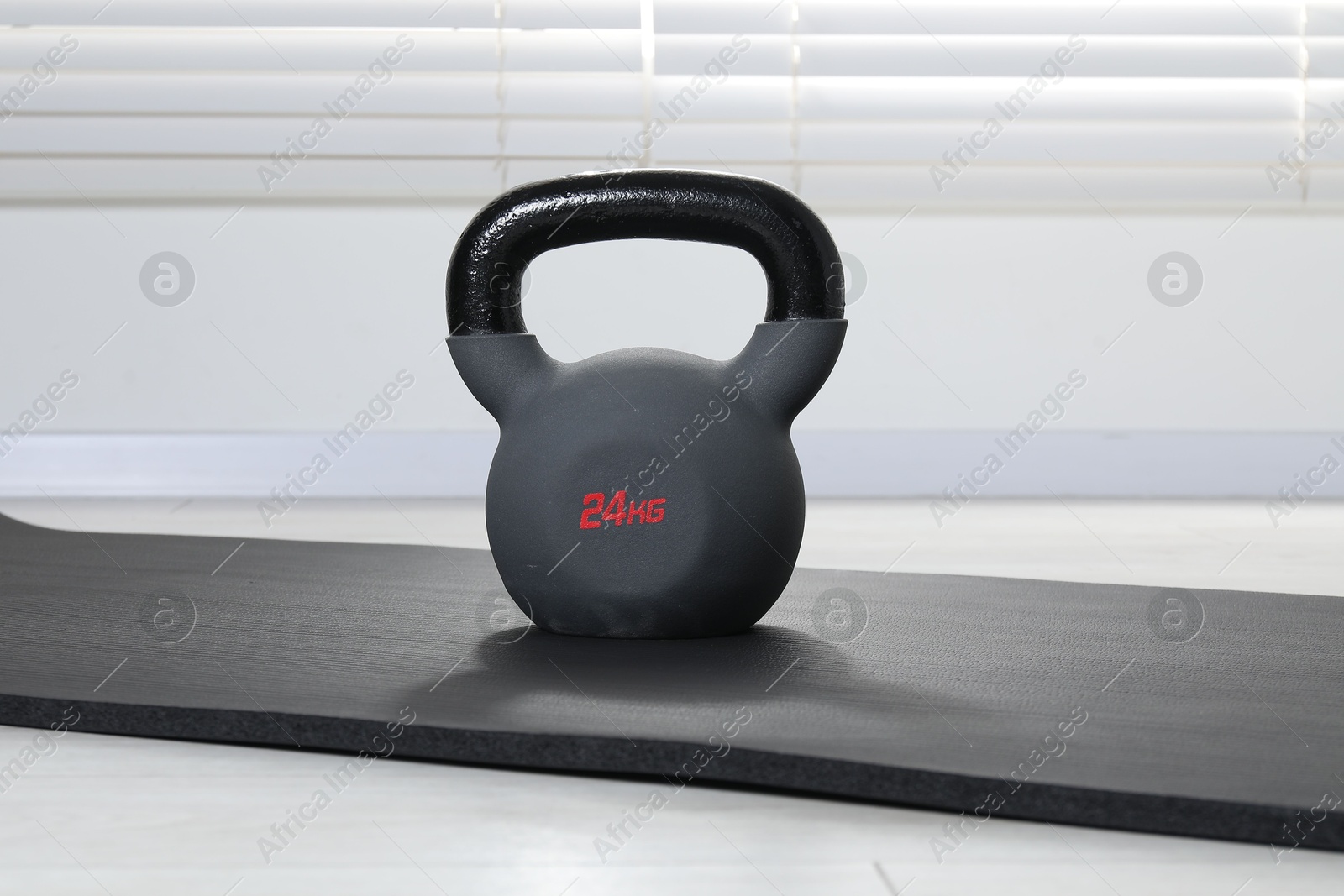 Photo of One kettlebell and mat on floor indoors