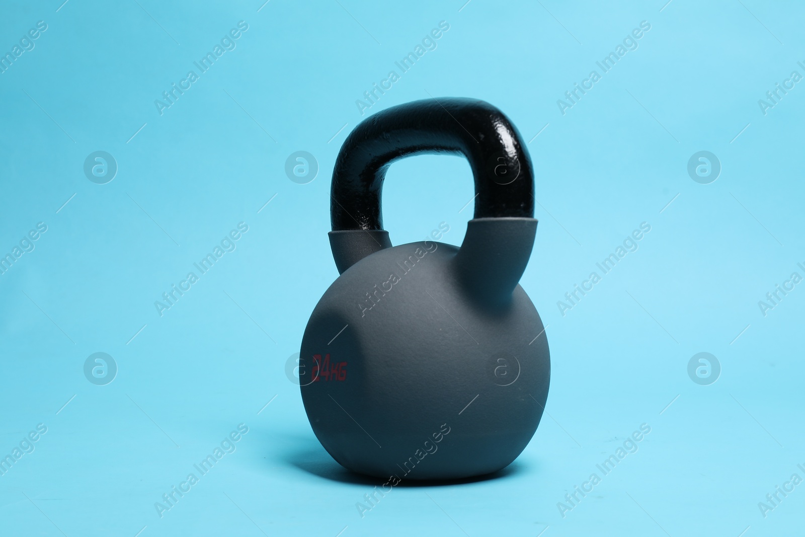 Photo of One heavy kettlebell on light blue background