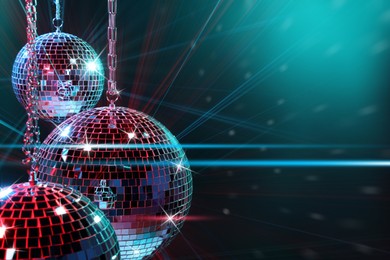 Image of Disco balls reflecting light on dark background. Nightclub decoration