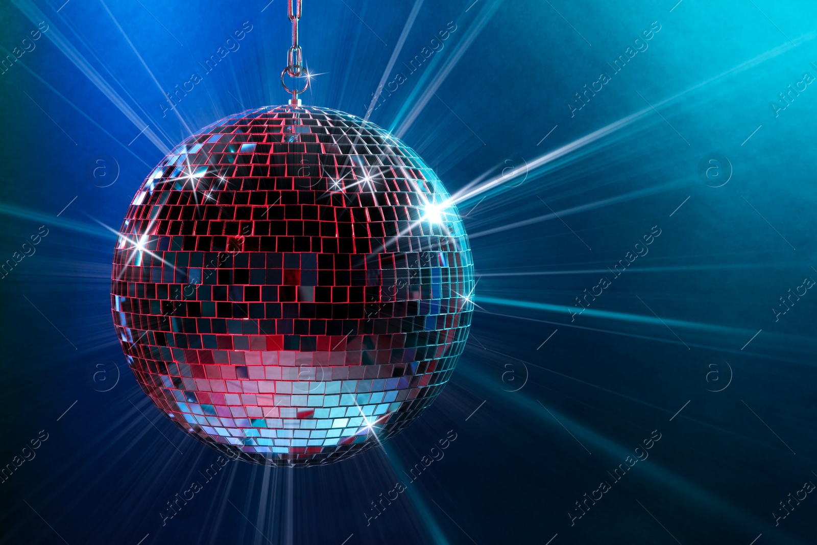 Image of Disco ball reflecting light on colorful background. Nightclub decor