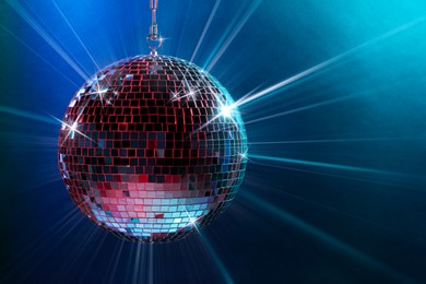 Image of Disco ball reflecting light on colorful background. Nightclub decor