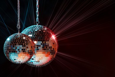 Image of Disco balls reflecting light on dark background. Nightclub decoration