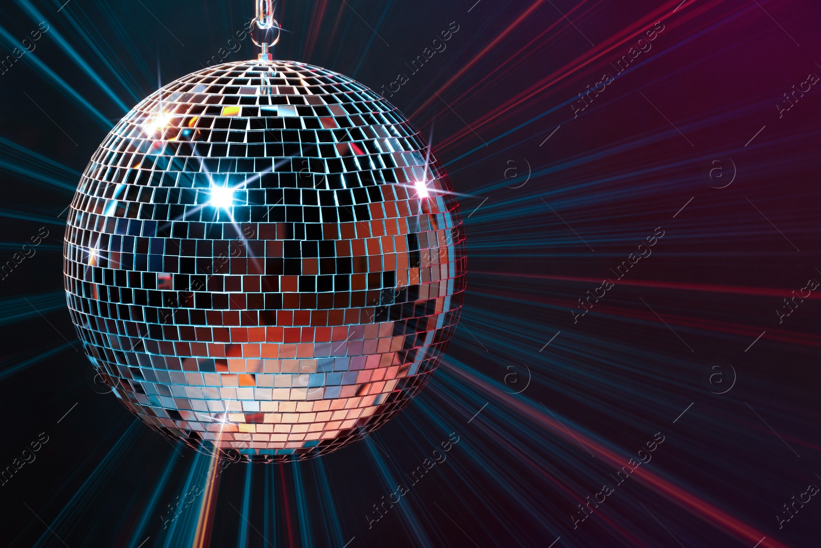 Image of Disco ball reflecting light on dark background. Nightclub decor