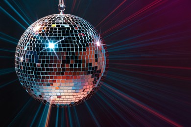 Image of Disco ball reflecting light on dark background. Nightclub decor