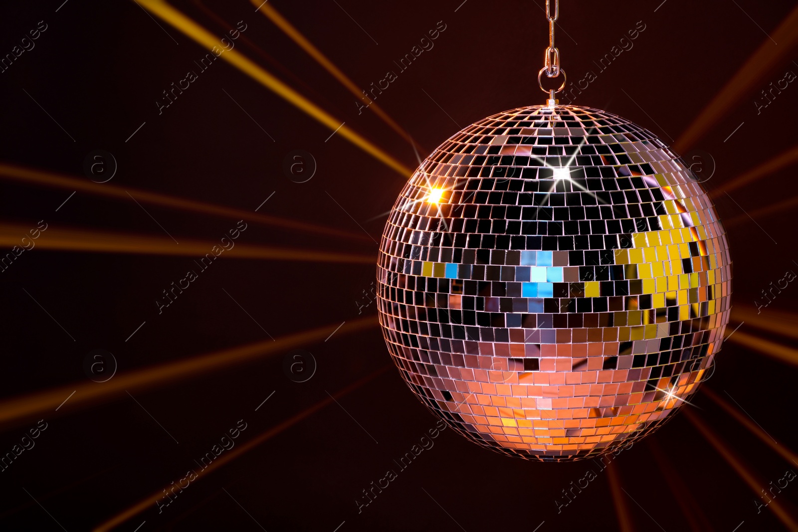 Image of Disco ball reflecting light on dark background. Nightclub decor