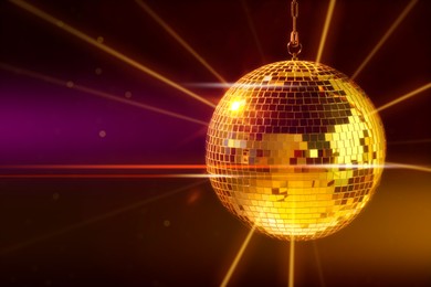 Image of Disco ball reflecting light on dark background. Nightclub decoration