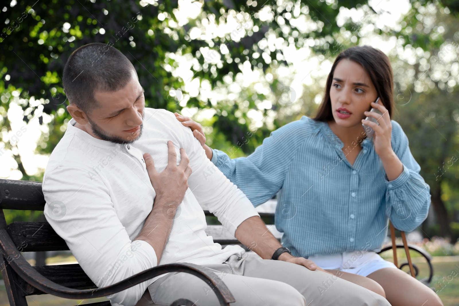 Photo of Woman calling ambulance to help man with heart attack in park