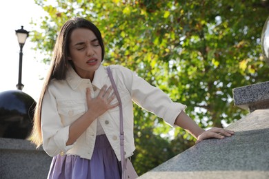 Photo of Young woman having heart attack in park