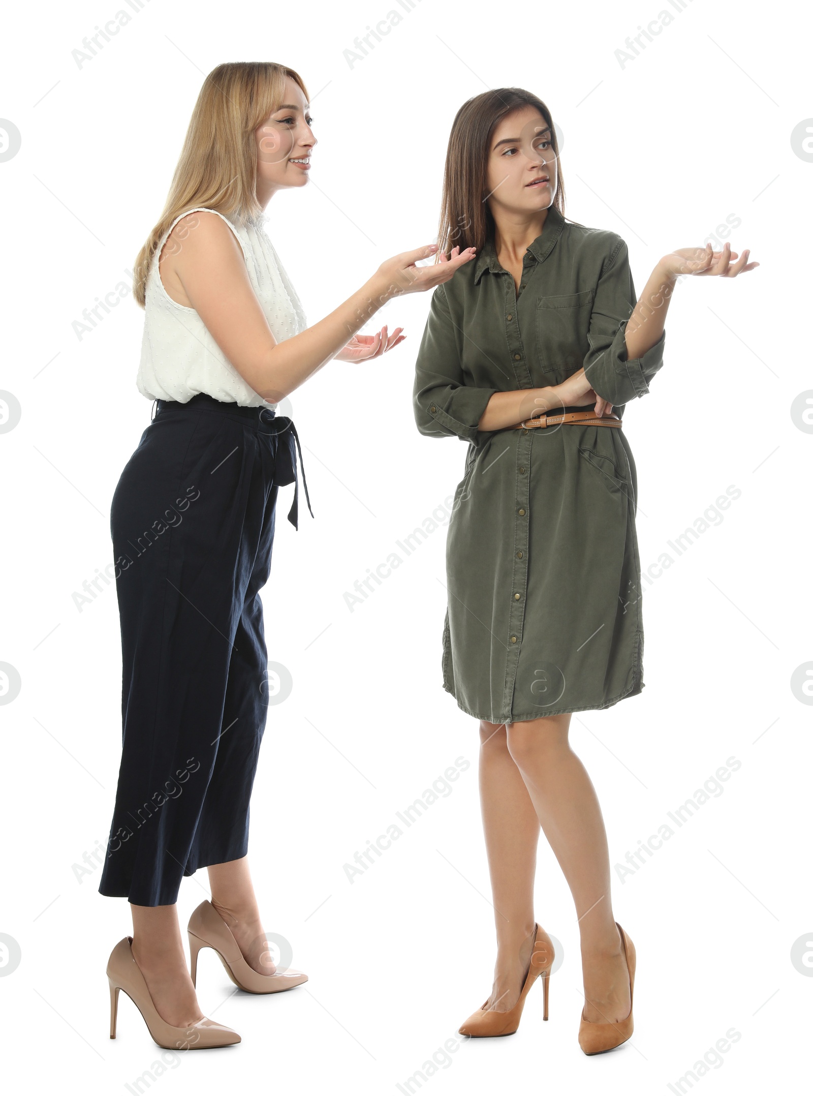 Photo of Young women in casual clothes talking on white background