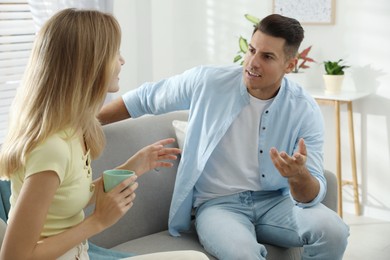 Photo of Man and woman talking in living room