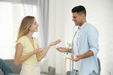 Photo of Man and woman talking in living room