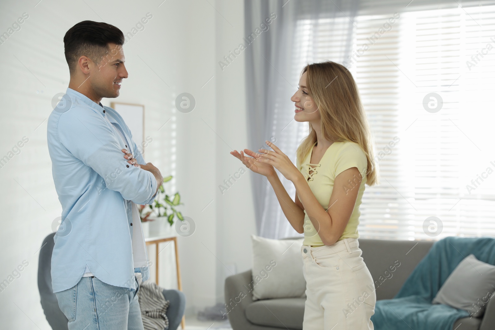 Photo of Man and woman talking in living room