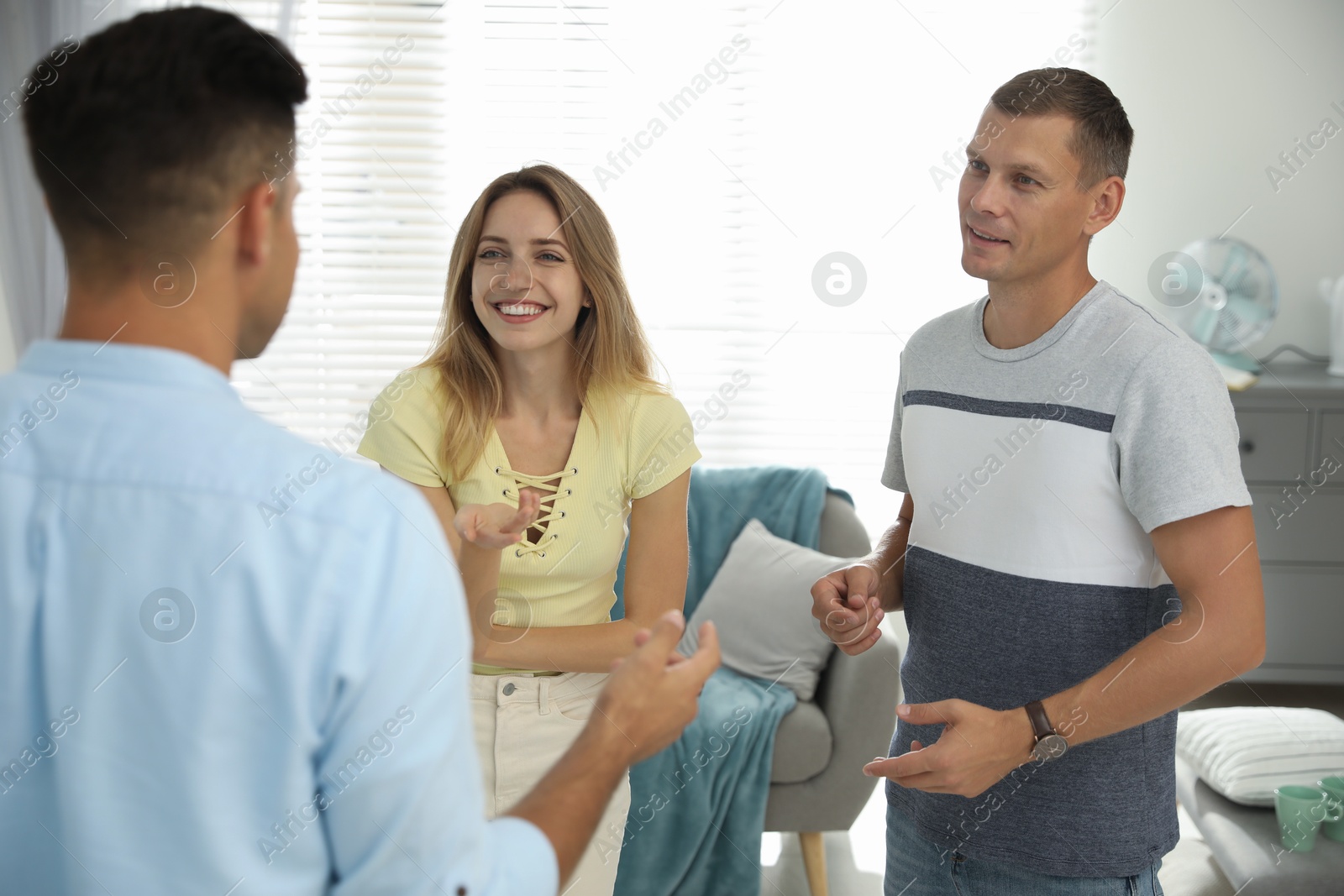 Photo of Group of people talking in living room