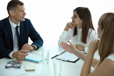 Office employees talking at table during meeting