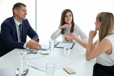 Office employees talking at table during meeting