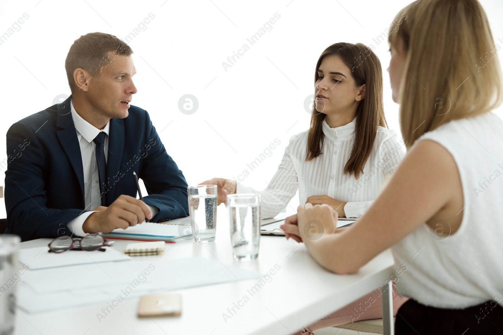 Photo of Office employees talking at table during meeting