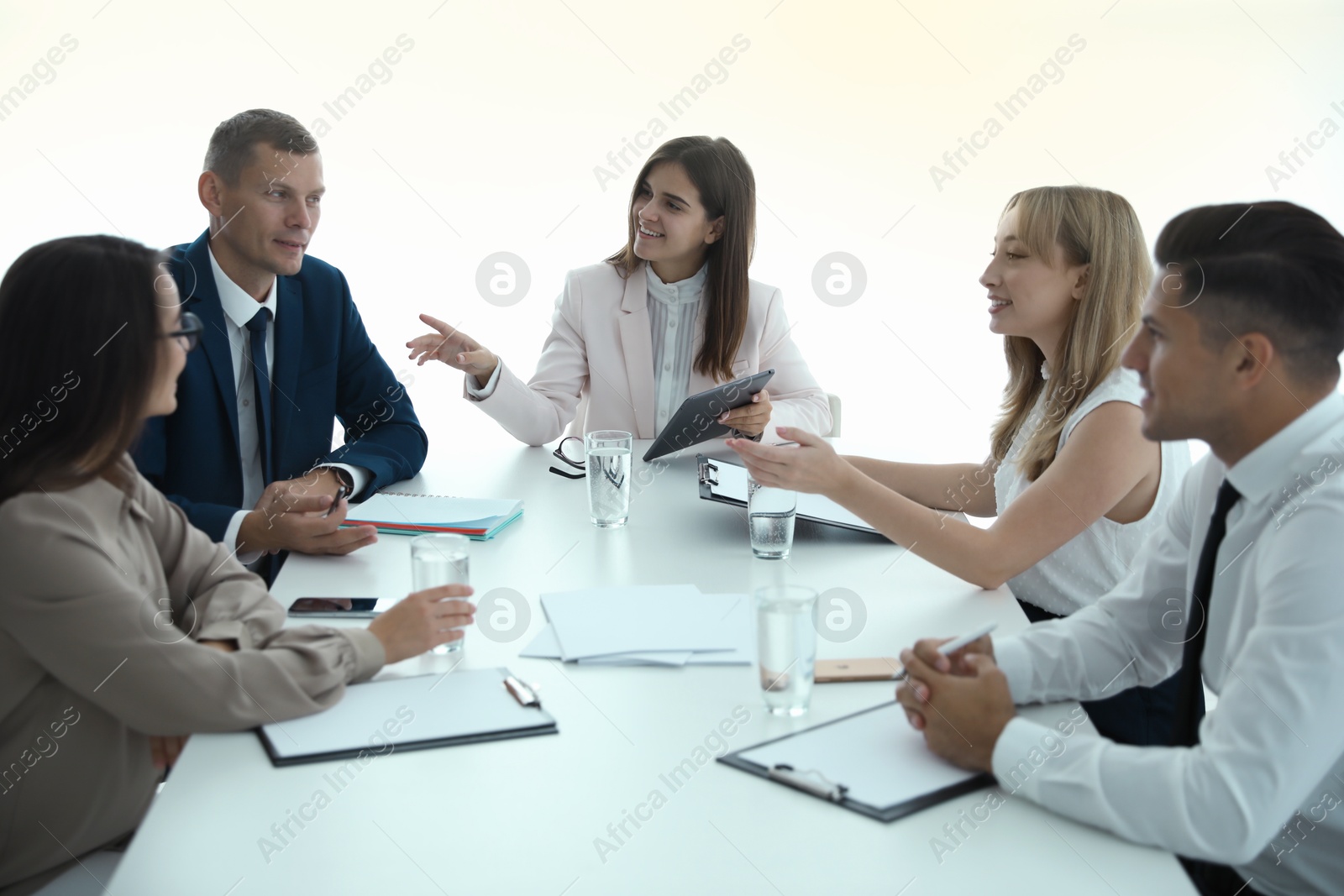 Photo of Office employees talking at table during meeting