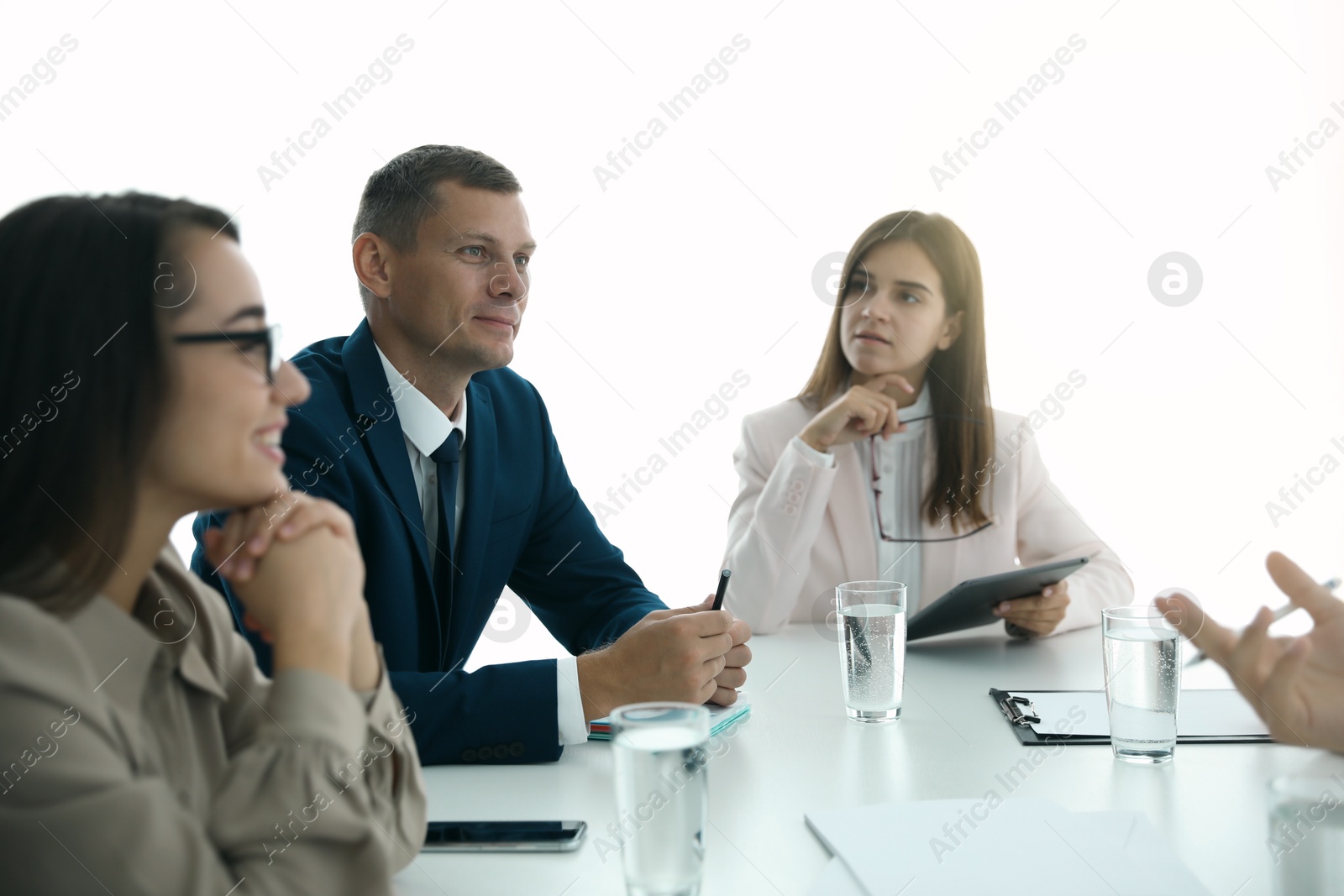 Photo of Office employees talking at table during meeting