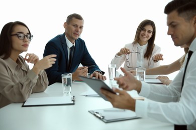 Office employees talking at table during meeting