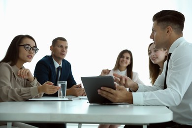 Photo of Office employees talking at table during meeting