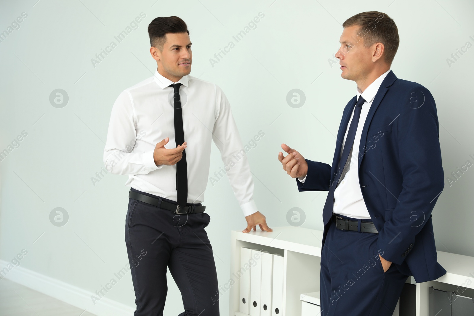 Photo of Office employees talking at workplace during break