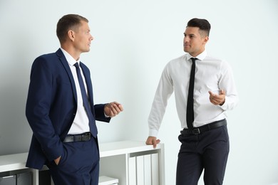 Office employees talking at workplace during break