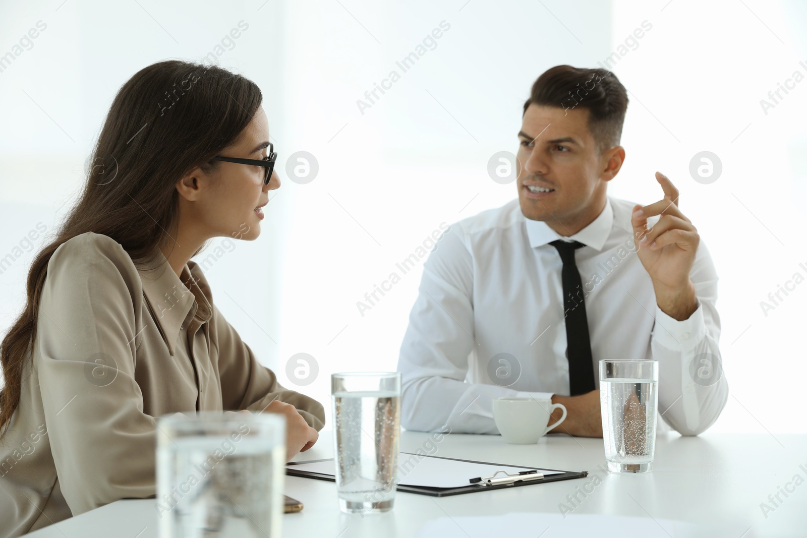 Photo of Office employees talking at table during meeting