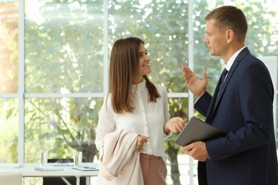 Office employees talking at workplace during break