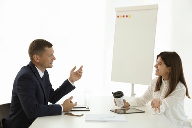 Office employees talking at table during meeting