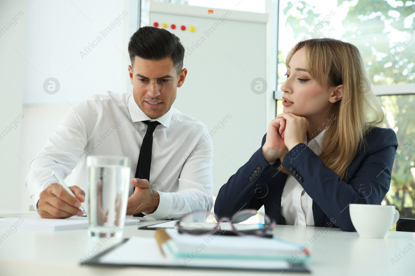 Photo of Office employees talking at table during meeting