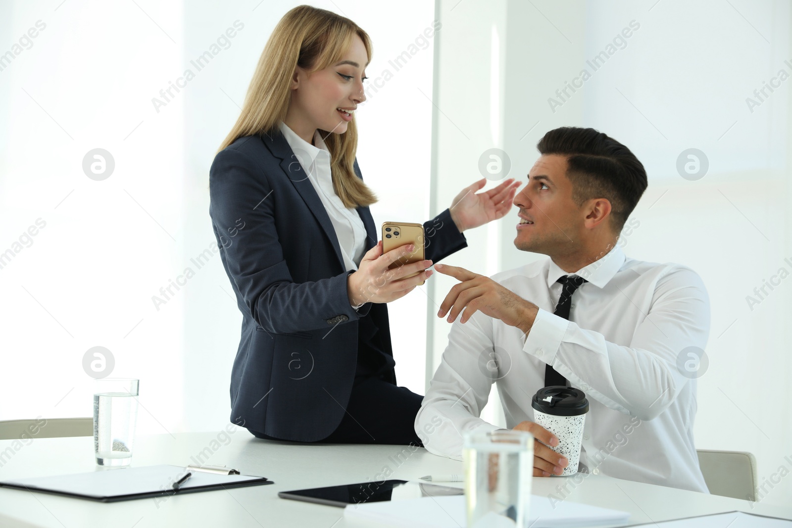 Photo of Office employees talking at workplace during break