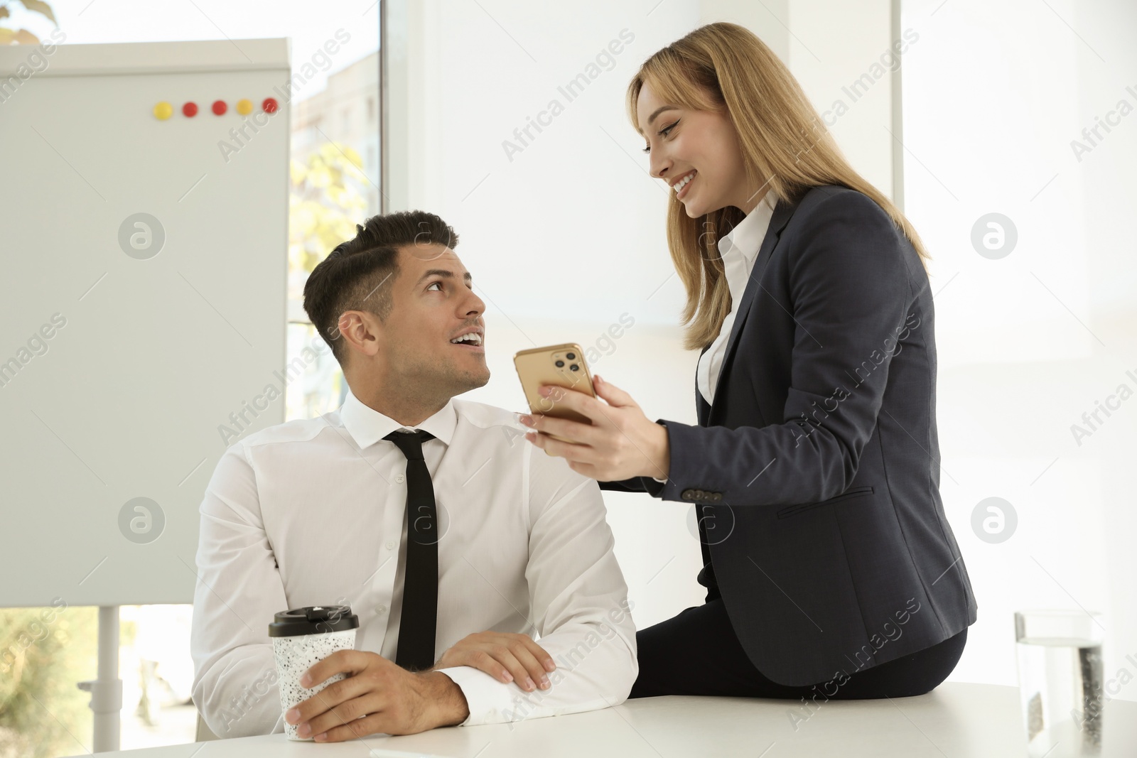 Photo of Office employees talking at workplace during break