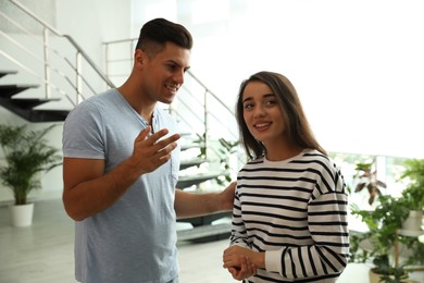 Photo of Man and woman having conversation in hall