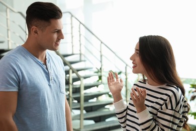 Photo of Man and woman having conversation in hall