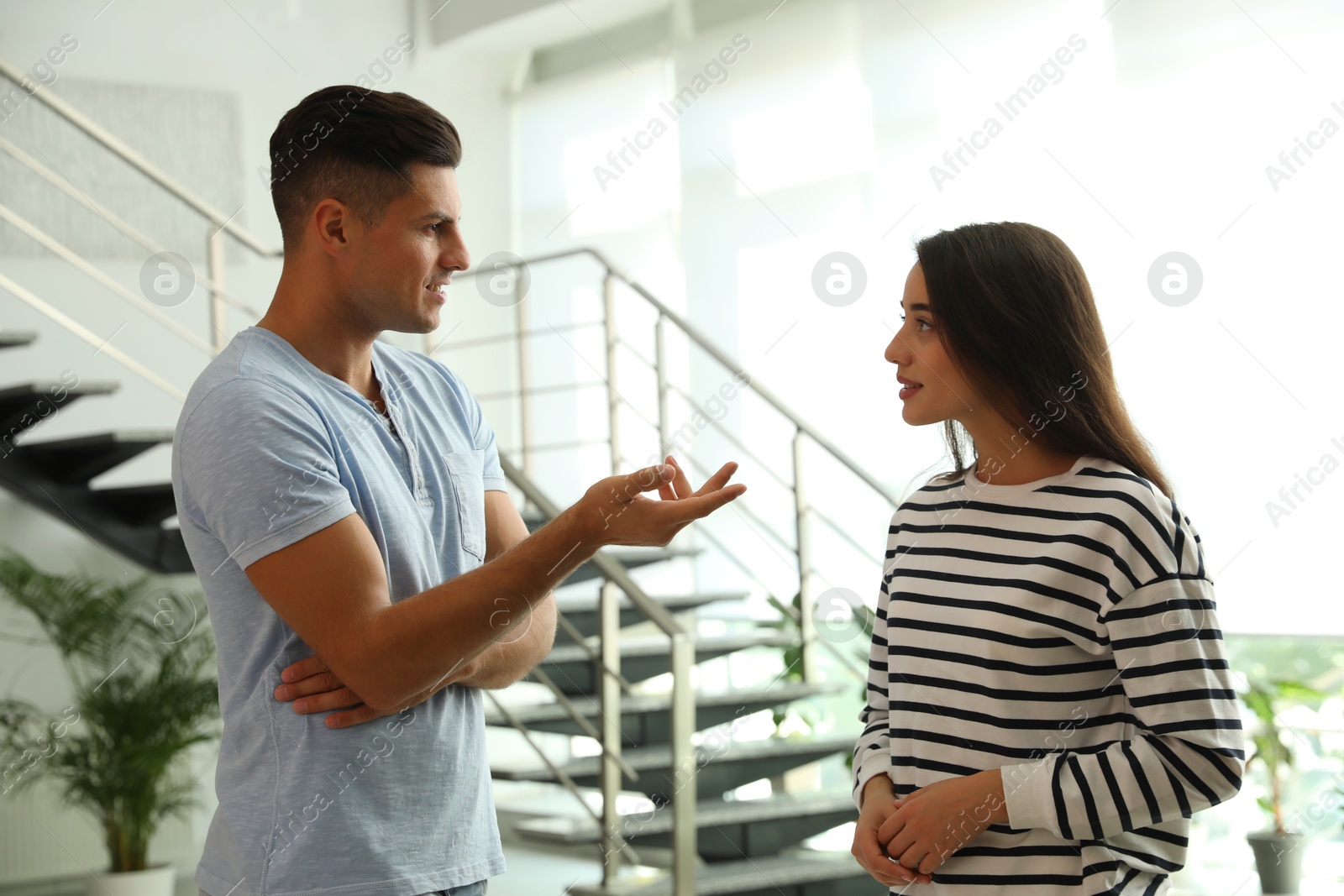 Photo of Man and woman having conversation in hall